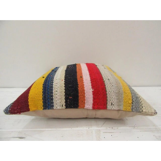 This is a pillow cover made from a vintage kilim rug. The piece was properly washed and ready to use. Pillow inserts not...