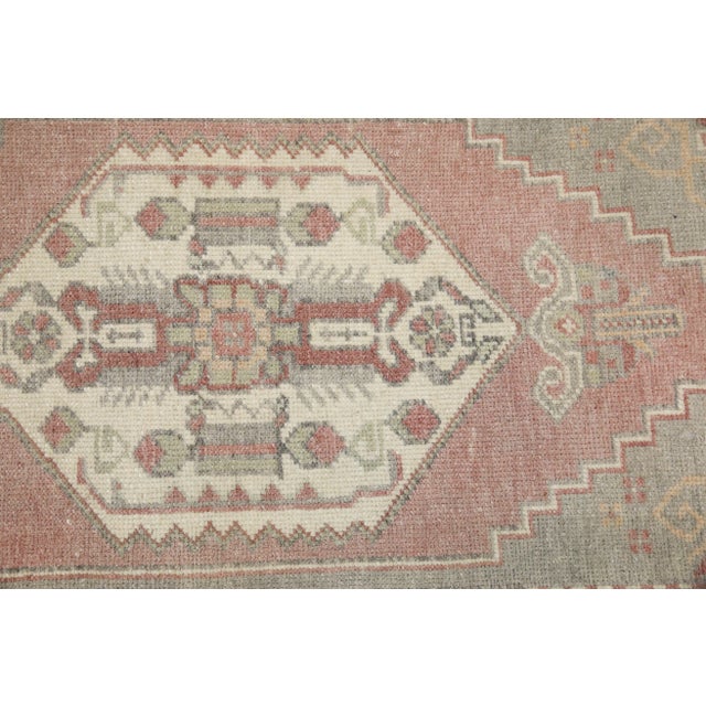 Introducing our exquisite vintage mini Turkish rug, expertly crafted by skilled artisans using traditional techniques that...