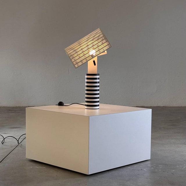 The 'shogun' table lamp, designed by mario botta for artemide in 1986, embodies the visionary architect's signature style...