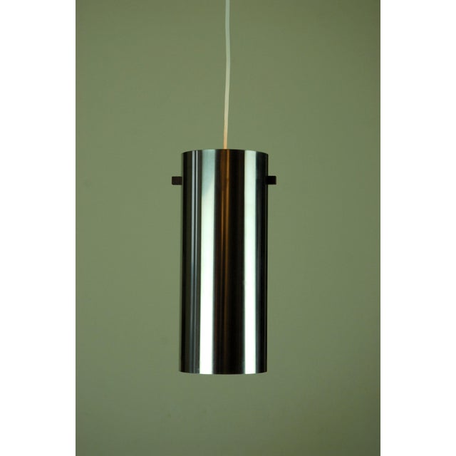 Luxus model number 571. Polished steel cylinder with a square hanging rod made of Rosewood with a light green plastic...
