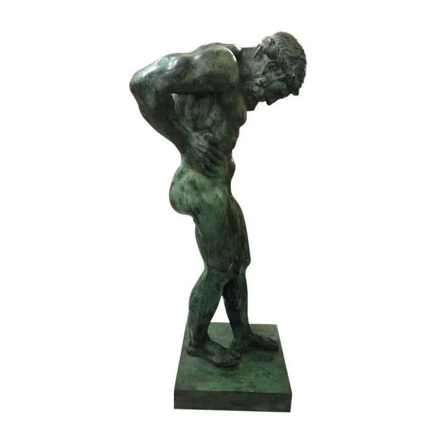 Atlas bronze of excellent casting and definition standing in and unusual pose with hands on his hips and normally with a...