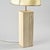 Large table lamp composed of a quadrangular travertine base, punctuated by three fine vertical grooves that accentuate the...