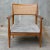 The warm brown color of this chair’s slender frame beautifully complements the cool gray upholstery of the tufted seat....