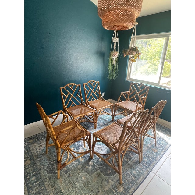 Gorgeous vintage rattan dining chairs attributed to Italian designer Dal Vera. Featuring chippendale styling fretwork and...
