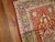 An early 20th century elegant handmade antique Turkish Oushak runner featuring three medallions on a pinkish red field...