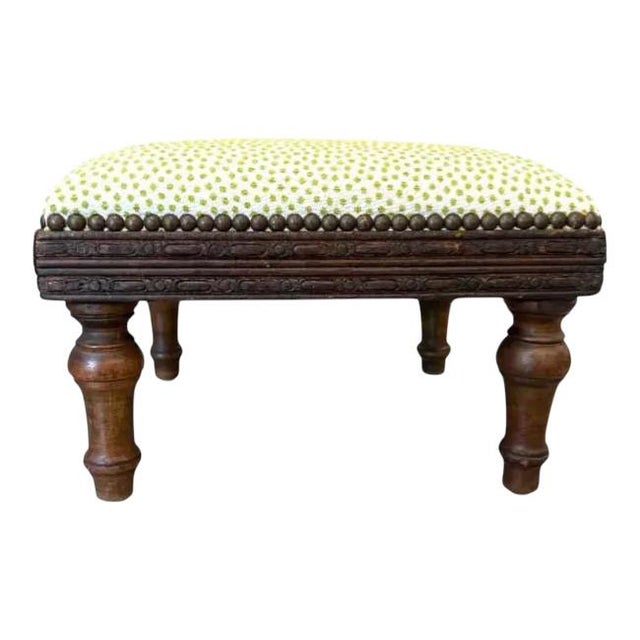 Antique-Style Upholstered Footstool Charming and timeless, this small wooden footstool features beautifully turned legs...