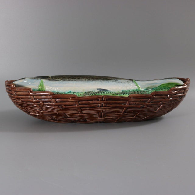 George Jones Majolica tureen with cover which features a salmon laying on a bed of ferns and other leaves. Colouration:...