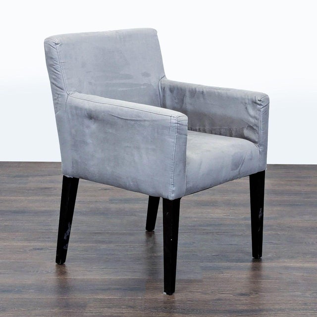 This West Elm lounge chair offers a clean and modern design with a soft gray fabric and sturdy black legs. The chair...