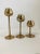 A fantastic set of 3 vintage brass graduated candlesticks shaped like tulips. These would look amazing on your coffee...