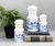 Charming set of three vintage white milk glass apothecary jars made in Belgium, each decorated with rich cobalt blue...