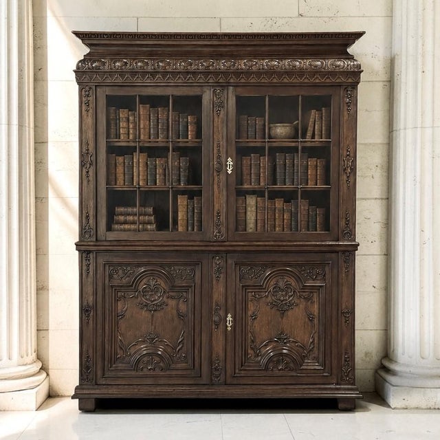 The artistry of 18th century French cabinetmaking is on magnificent display in this Régence period carved oak bookcase. A...