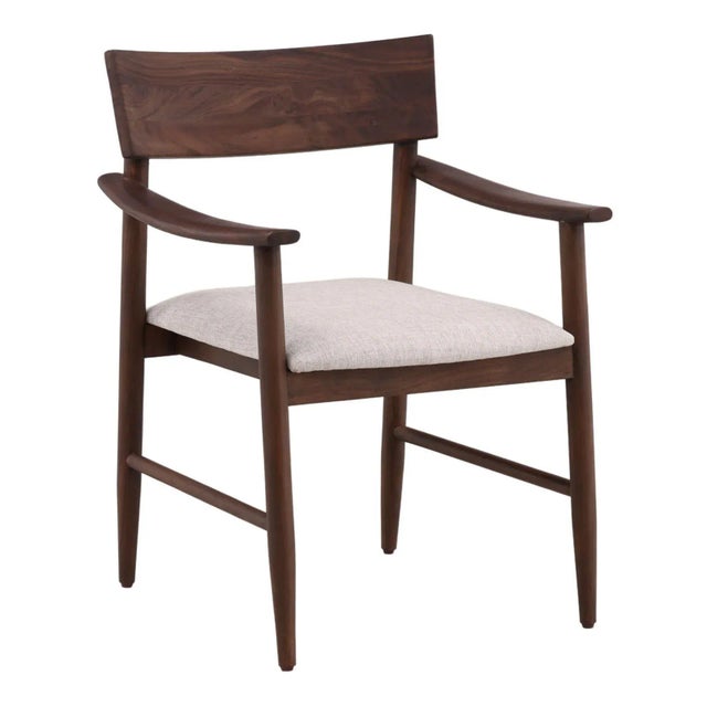 Walnut brown finish solid acacia wood frame dining arm chair with soft cream toned cotton blend seat. Each will vary in...