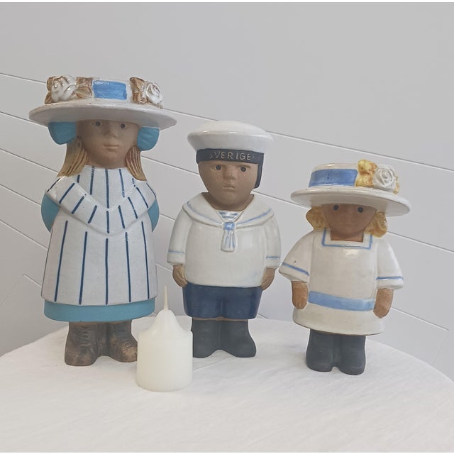 Presenting an exceptional, highly rare three-piece vintage collection of chamotte stoneware figures designed by the...