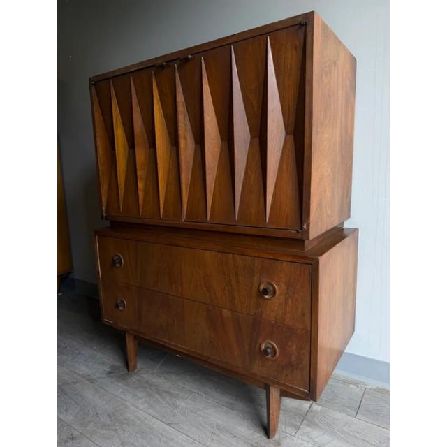 A mid-century modern gentleman's chest designed by Merton Gershun for American of Martinsville, this popular Harlequin...