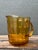 Add a touch of Mid-Century warmth to your glassware collection with this striking amber glass pitcher. Defined by its...