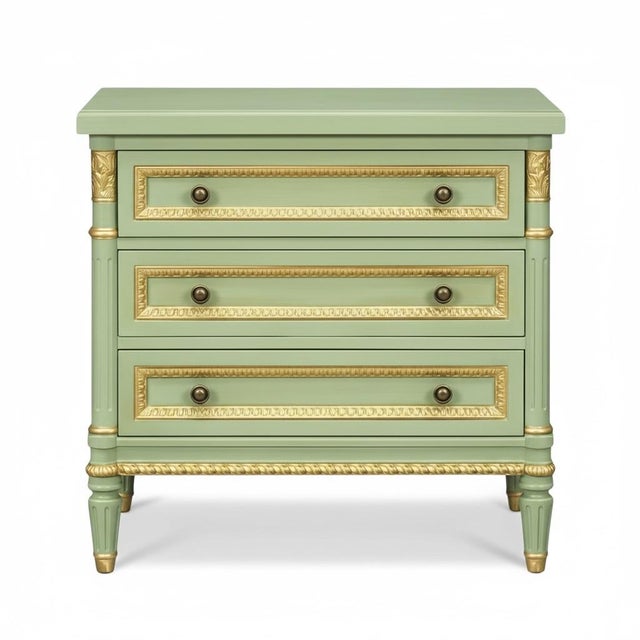 This is a pair of French Louis XVI style chests or side tables attributed to Julia Gray. They are green with gilt accents...