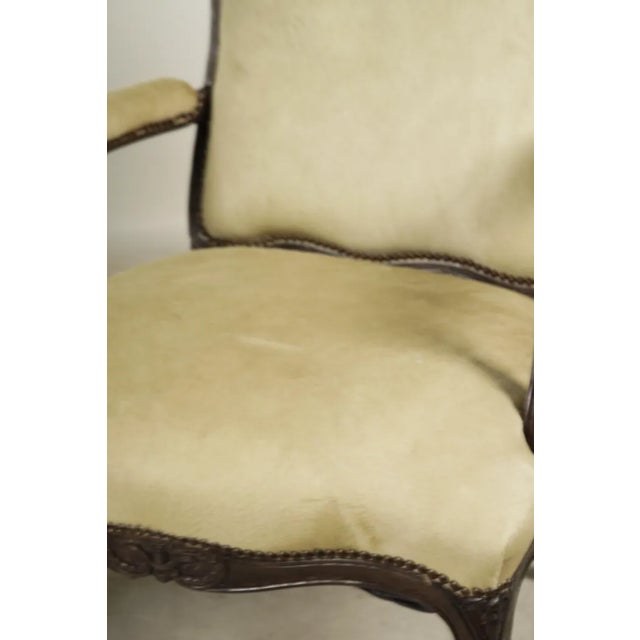 A Pair of French Country Louis XV-Style Fauteuils 20th century; covered with pale white hide leather and brass nailhead...