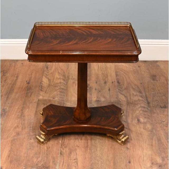 An elegant Regency style mahogany occasional table with attractive figured veneers The rectangular top has gently rounded...