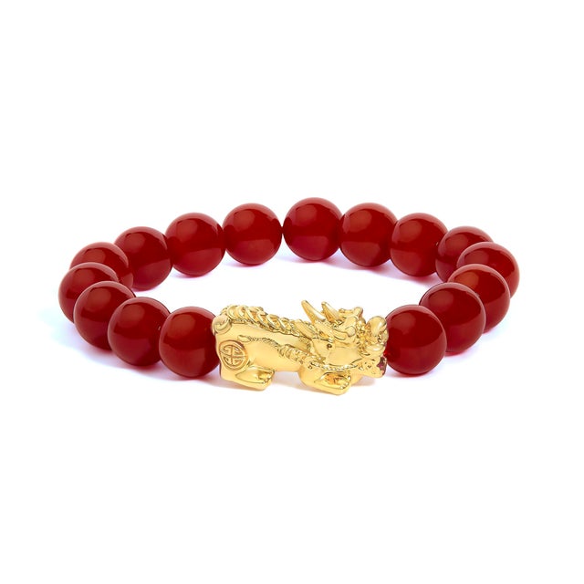 Fire-kissed red meets luminous gold in this captivating beaded bracelet, a talisman of strength and auspicious beginnings....