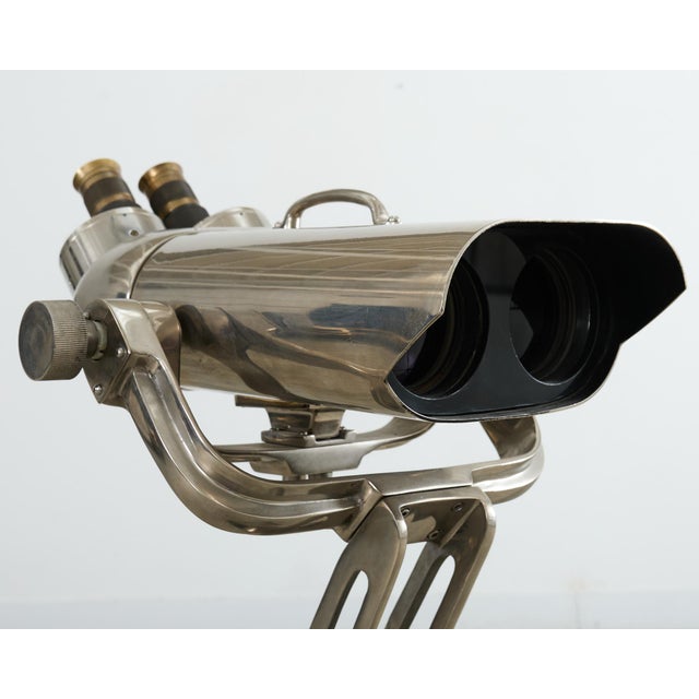 Industrial 20th WWII style naval anti-aircraft binoculars mounted to a large adjustable height tripod stand. Constructed...