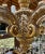 A large baroque style handcarved, gilded Chandelier with wax candle sleeves. This is a wonderful piece for a large Entry.
