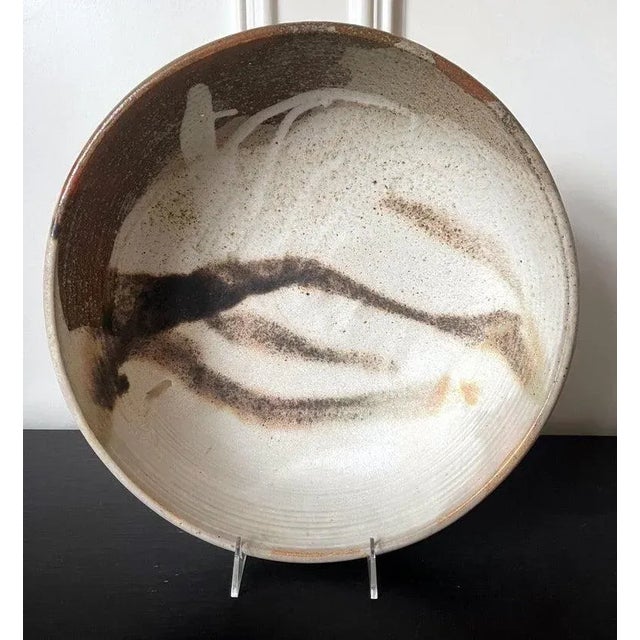 A large ceramic tea center bowl by Japanese American artist Toshiko Takaezu (American, 1922 - 2011). Meant to be a...