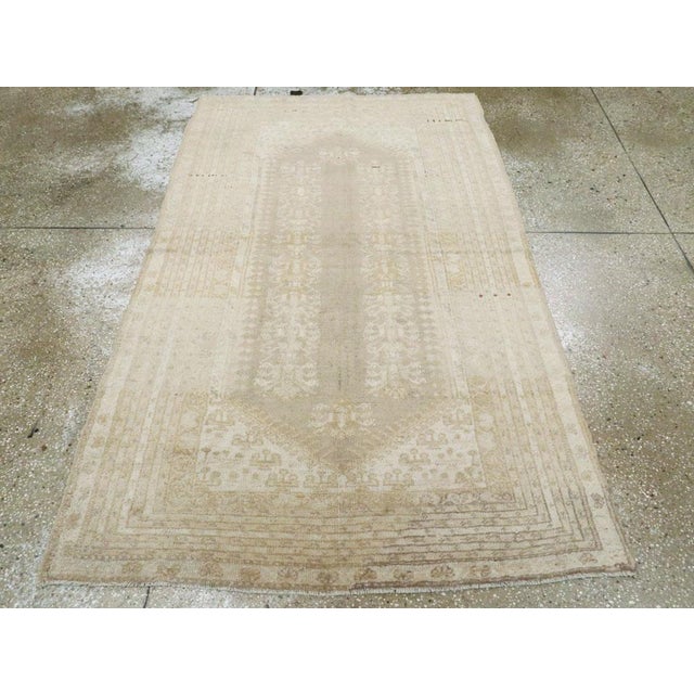 An antique Turkish Ghiordes rug. In the style of an antique Turkish Kula, this scatter has two floral “trees” ornamenting...