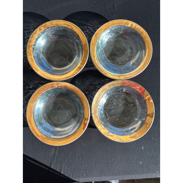 A set of four Annieglass Roman Antique bowls, each hand-formed with a wide, shallow profile and finished with a band of...
