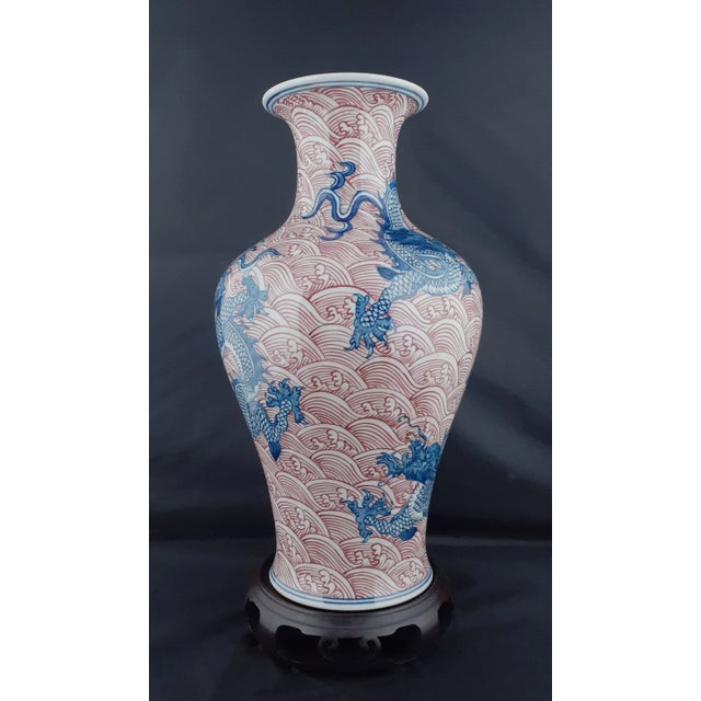 Chinese porcelain dragon haitangzun, white glazed interior and inset base. Three finely drawn, blue and white, five clawed...