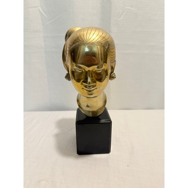 This striking mid-century sculptural bust is a rare, high-polished edition of the iconic "Head of a Young Woman" by...