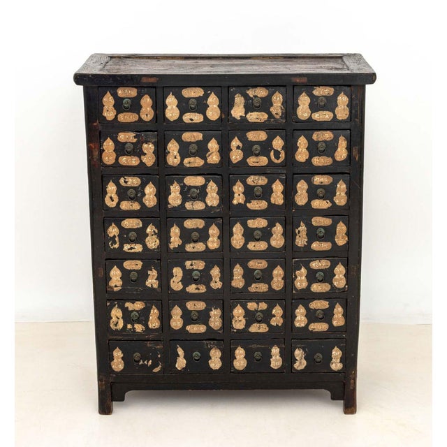 Chinese Ebonized Wood Apothecary Chest, 19th century, with gilt double gourd motif to the 28 drawers, each drawer opening...