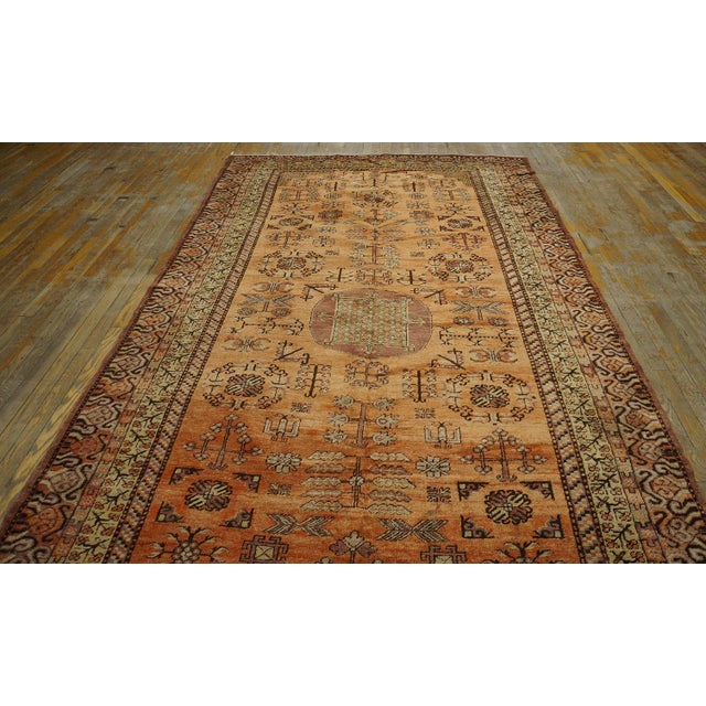 Antique Chinese Khotan rug, size: 5'8" x 11'4". Antique Khotan East Turkestan Coral 1900s Rug, Circa Date: 1900s. This...