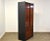 A mid century modern rosewood and black lacquered armoire dresser with chrome accents in the style of Harvey Probber and...