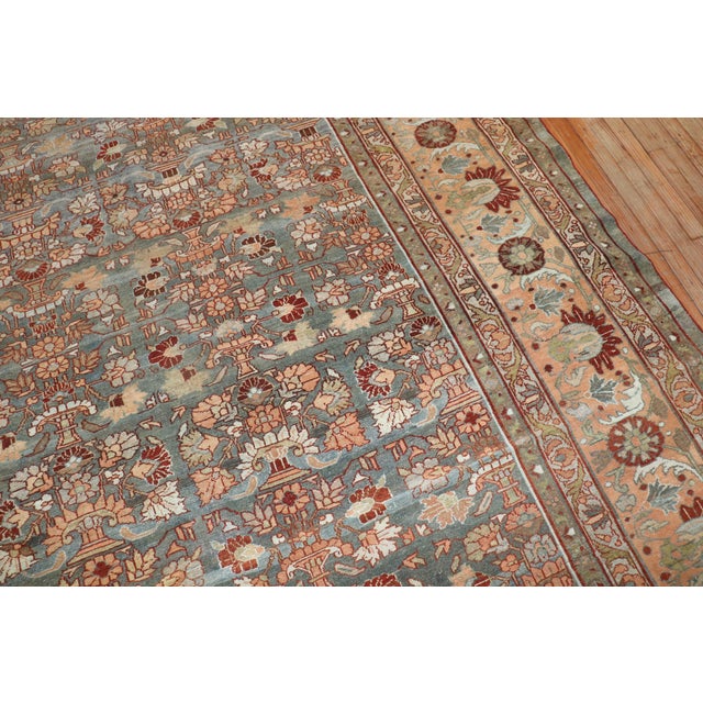 An early 20th century Persian Malayer oversize rug with an all-over floral repetitive design Measures: 14'4'' x 18'1''.
