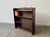 This is an antique 20th century free standing book shelf unit crafted from oak. The surfaces show an attractive distressed...