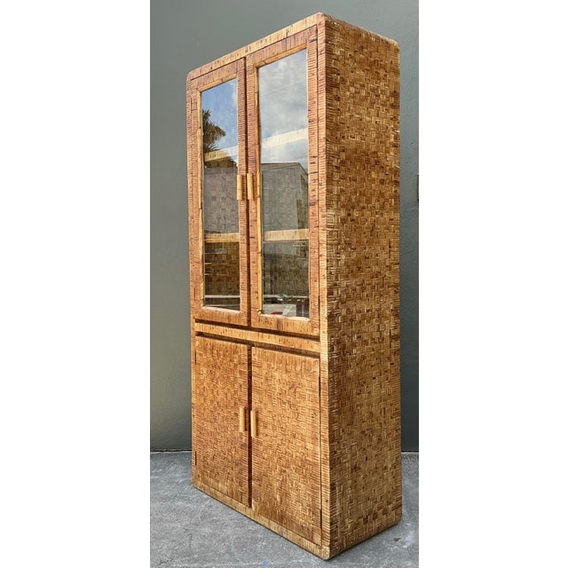 This striking vintage cabinet is a masterclass in organic texture, perfectly capturing the breezy sophistication of 1970s...