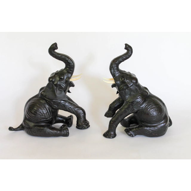 Pair of vintage leather elephants with the trunks up. No makers mark. Minor signs of wear.