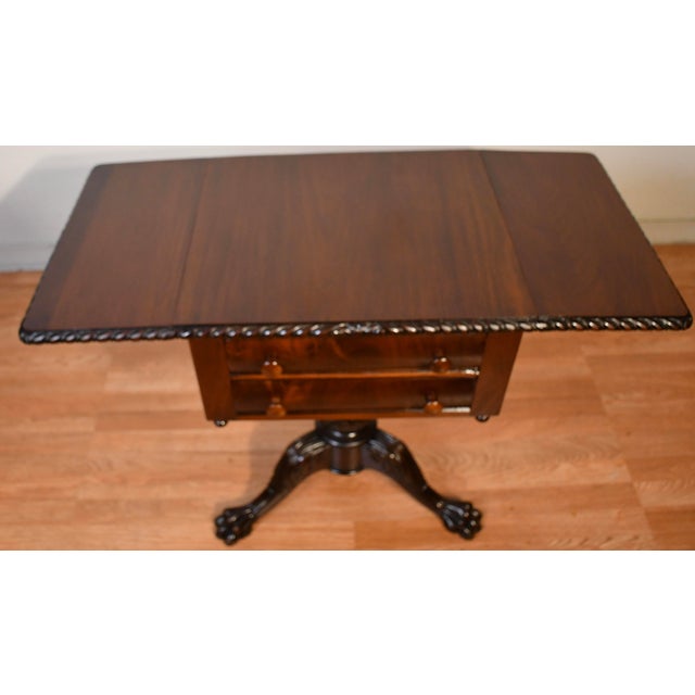 We are pleased to offer this beautiful Antique American Empire Work table, From the 1910s . This table is made of Mahogany...