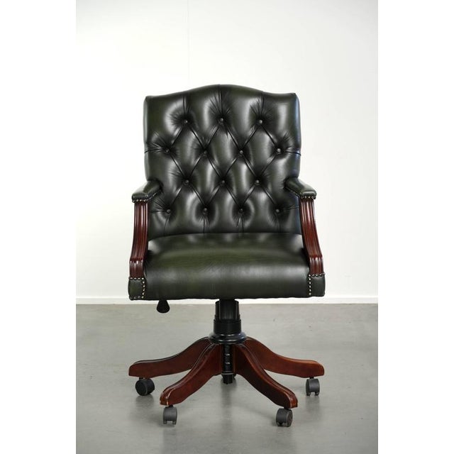 This beautiful green English-style Chesterfield office chair is made of cowhide leather. It is height-adjustable, features...