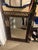 Decorative wrought iron wall mirror featuring an elegant scrolling motif and bronze finish. The intricate openwork frame...
