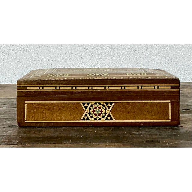 This exquisite vintage Moroccan box showcases the storied tradition of intricate wood marquetry and geometric mosaic art....