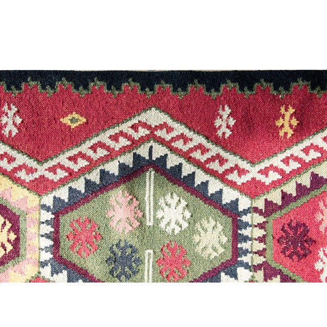 A bold and beautiful late 20th century Afghani kilim runner with five large diamond medallions, each with large stylized...