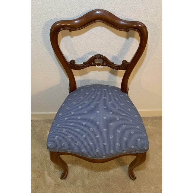 Vintage low back Italian style chair with upholstered seat and decorative carved legs.