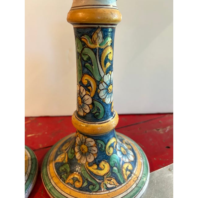 A pair of hand painted vintage candle holders signed Alessi Caltagirone