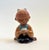 A vintage mid century pottery girl. Lovely detailing with a carved floral design to the girl's jacket. Unglazed natural...