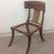 Robsjohn Gibbings style Klismos dining chair. The chair is made of walnut. The leather cording is round. The finish is a...