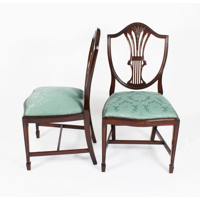 This fantastic set of seven vintage wheatsheaf shieldback dining chairs, dates from the mid 20th century. Masterfully...
