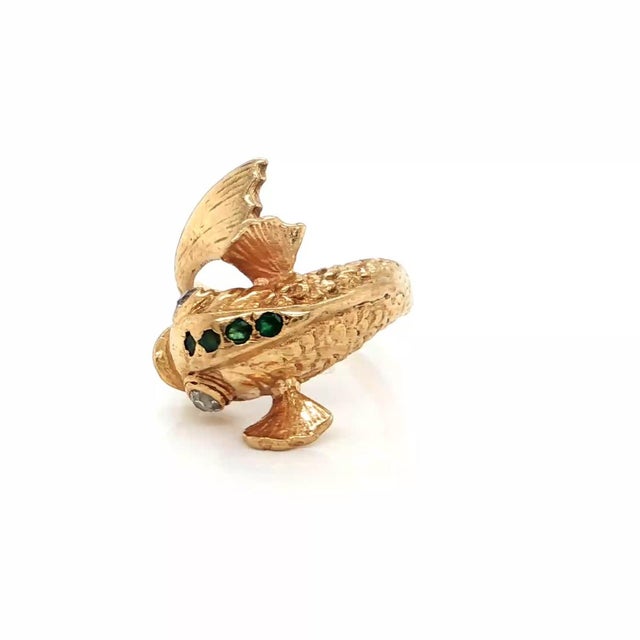 This authentic estate fish motif ring is crafted in solid 14k yellow gold and features a beautifully sculpted bypass...