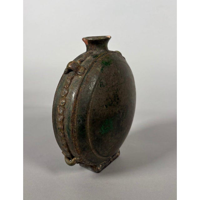 Green-glazed earthenware Bianhu flask of a nomadic horseman, China, Tang Dynasty (618-907). This piece, made of monochrome...