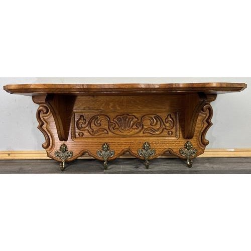 This charming Vintage French coat hanger wall shelf features finely carved wood detailing with elegant scrollwork and...